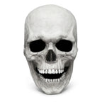 Bone white movable-jaw skull mask shown alone on a plain pale studio background, straight front view