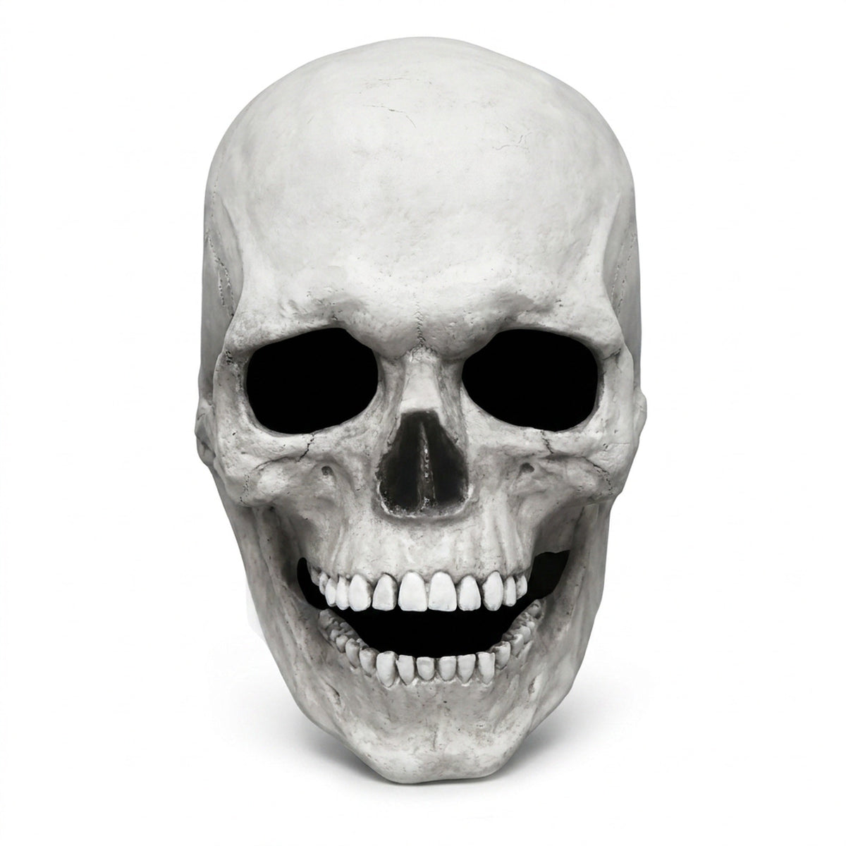 Bone white movable-jaw skull mask shown alone on a plain pale studio background, straight front view