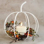 White Metal Cage Pumpkin candle holder adding warmth and rustic charm to home decor.